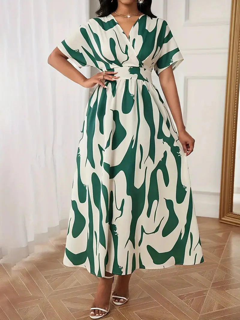 Woman wearing a green and white patterned dress indoors.