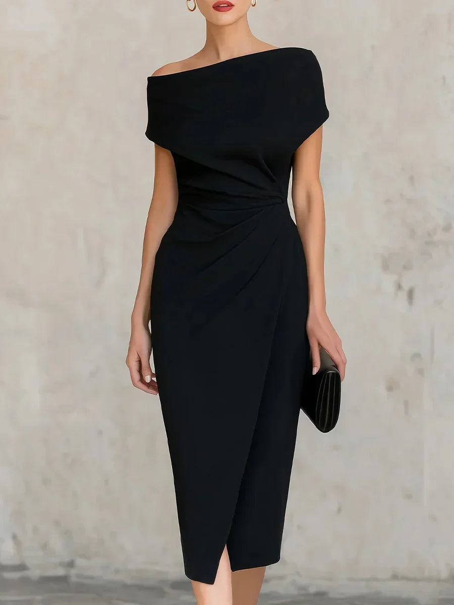 Black off-shoulder dress worn by a model against a neutral background