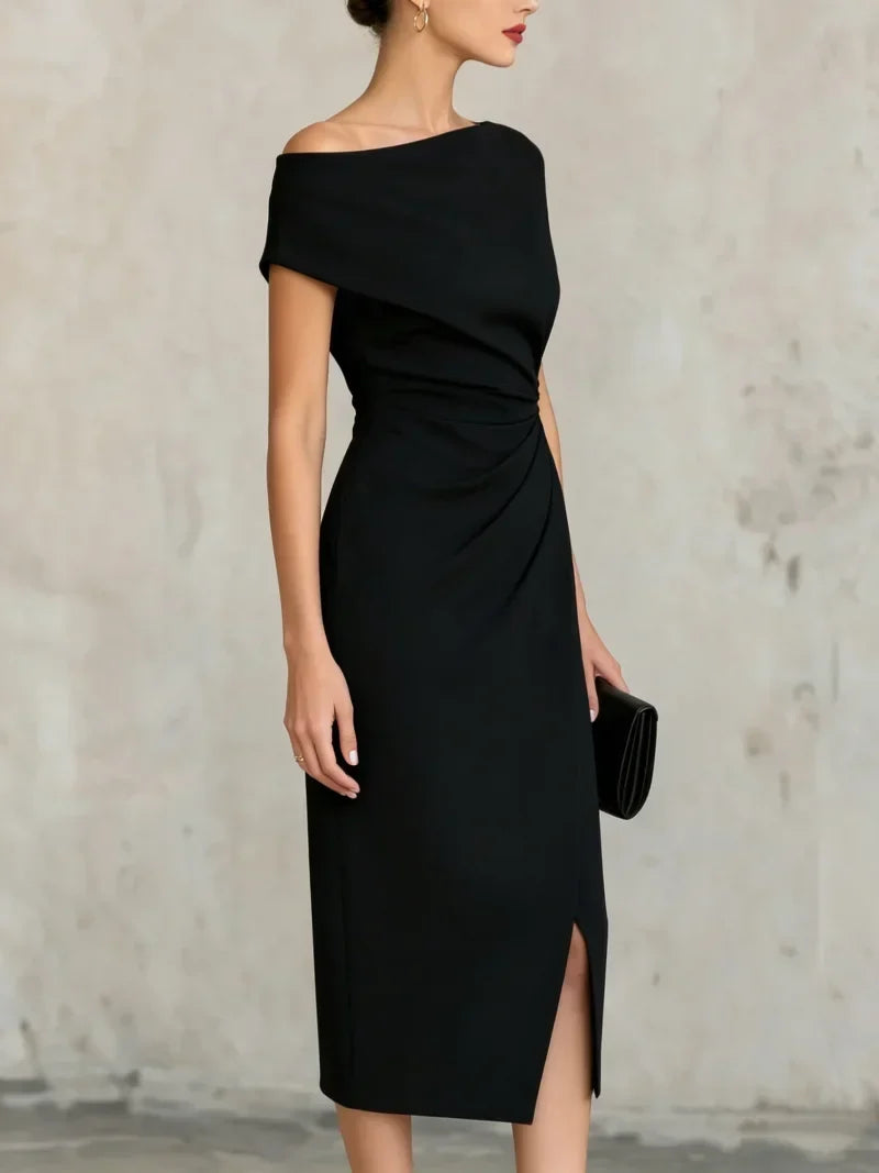 Black one-shoulder dress with a slit on a plain background
