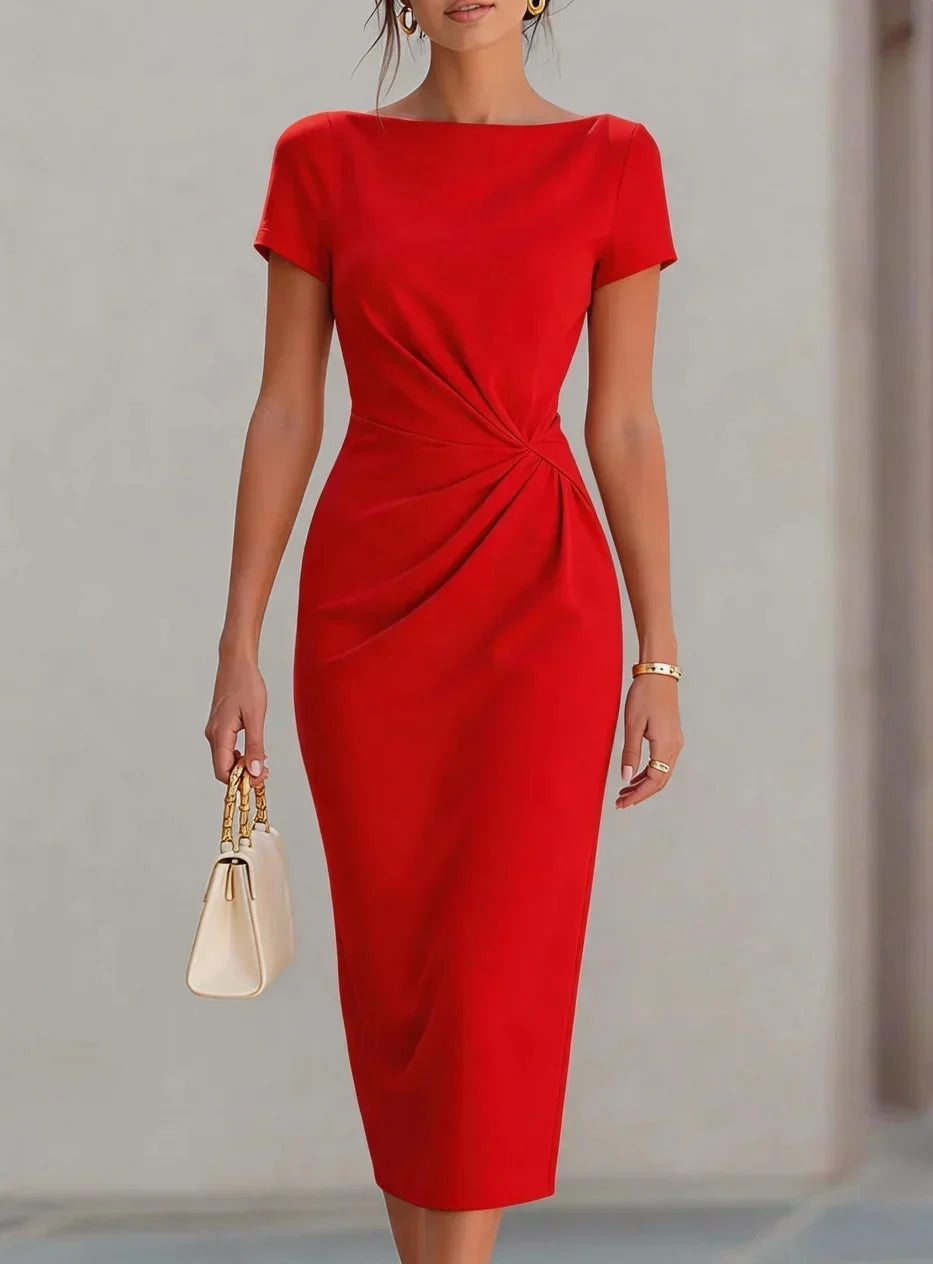 Red dress with a knot detail on a plain background